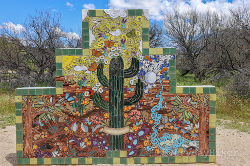 An artistic mural located at the beginning of the trail. The center of the mural sports a multi-armed Saguaro, while around it are multiple desert animals drawn in a playful style. The sun and the moon may be seen in the upper portions of the mural.