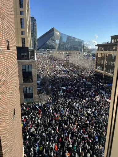 A crowd of thousands of people in a large open space in minneapolis participating in the general strike